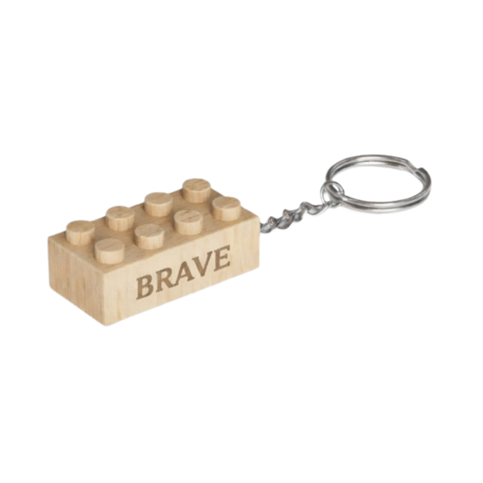 Timber Brands engraved wooden brick keychain with “Brave” message, compatible with plastic brick systems