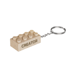 Timber Brands engraved wooden brick keychain with “Creator” message, compatible with plastic brick systems
