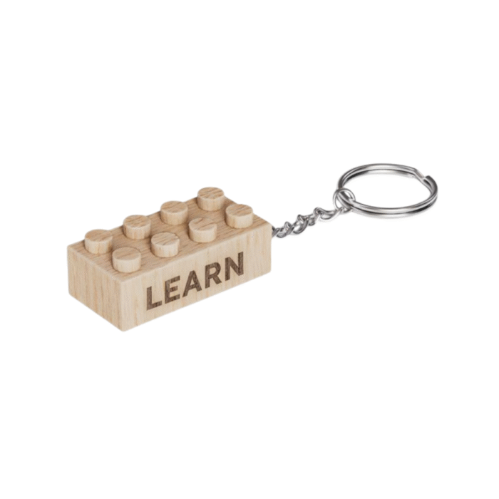 Timber Brands engraved wooden 2x4 brick keychain featuring the word “Learn,” compatible with plastic brick systems