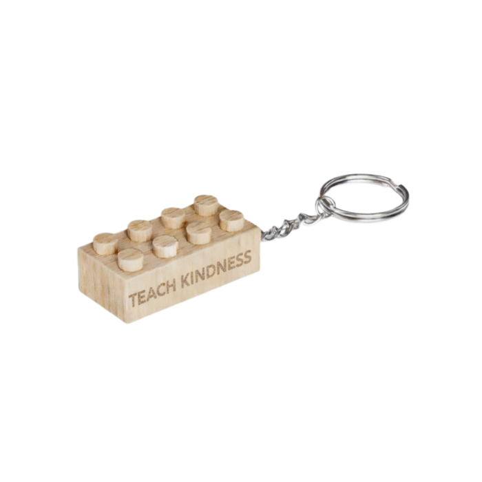 Timber Brands engraved wooden 2x4 brick keychain featuring the phrase Teach Kindness, compatible with plastic brick systems