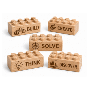 Custom engraved standard 2x4 wooden bricks featuring motivational words Build, Create, Solve, Think, and Discover with nature-inspired icons. FSC-certified eco-friendly wood building blocks compatible with LEGO-compatible bricks and made in the USA for creative learning and STEM-inspired play.