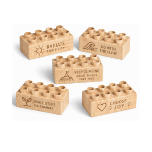 Custom engraved 2x4 plus size wooden bricks compatible with LEGO DUPLO featuring motivational phrases including Radiate Positivity, Go With the Flow, Keep Climbing, Small Steps Big Changes, and Choose Joy. FSC-certified eco-friendly wood building blocks made in the USA for mindfulness, confidence-building, and creative play.