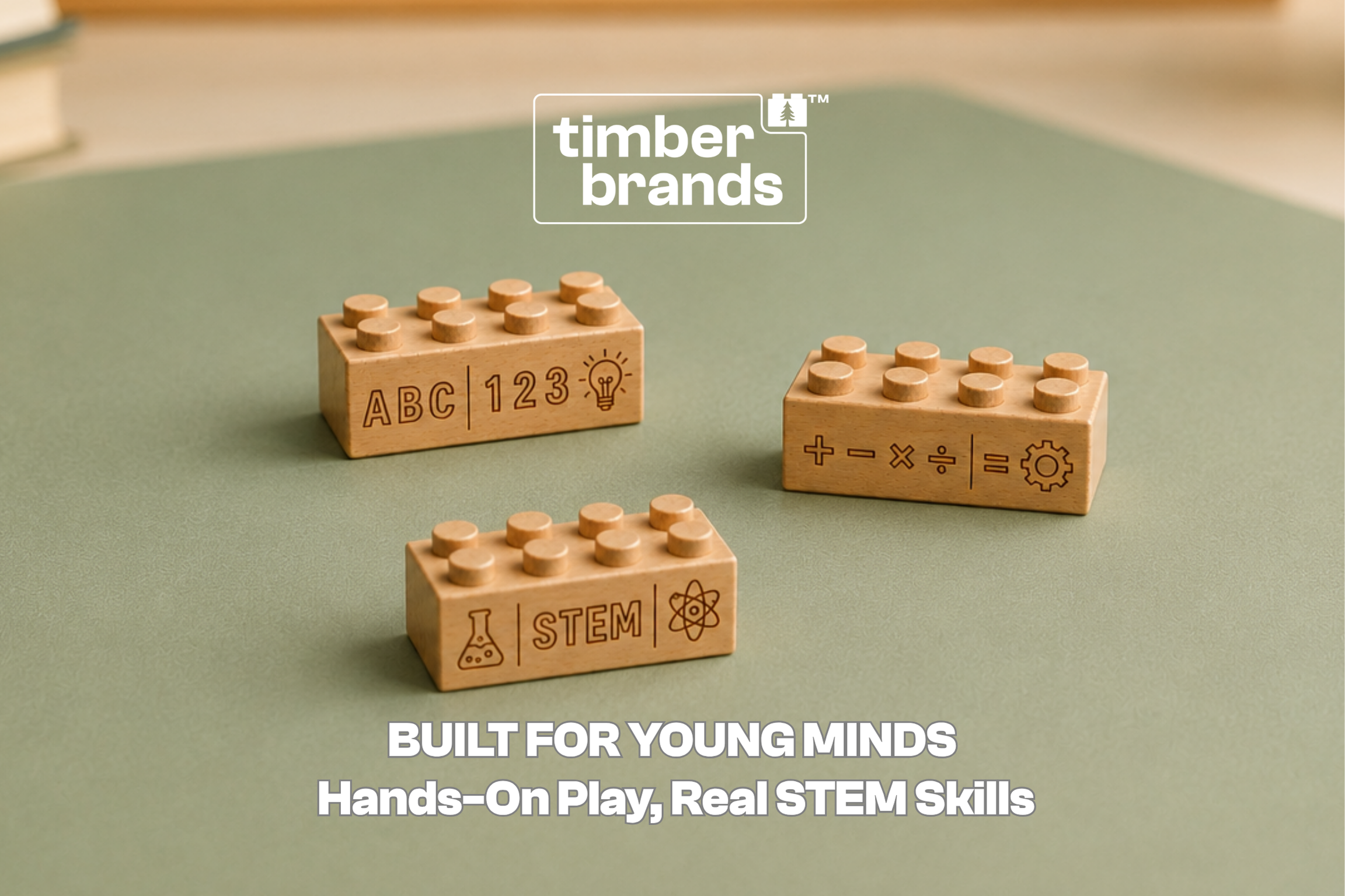 Three Timber Brands wooden building bricks engraved with letters, numbers, math symbols, and "STEM" on a green surface, beneath the words "Built for Young Minds."