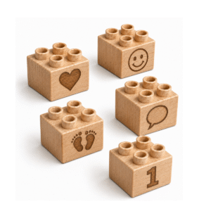 Set of five custom engraved wooden Plus bricks with baby icon designs including heart, smiley face, footprints, speech bubble, and number 1