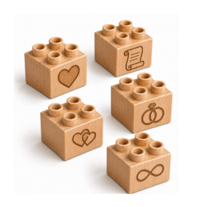 Set of five custom engraved wooden Plus bricks with wedding icon designs including heart, scroll, interlocking hearts, rings, and infinity symbol