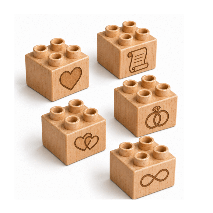 Set of five custom engraved wooden Plus bricks with wedding icon designs including heart, scroll, interlocking hearts, rings, and infinity symbol