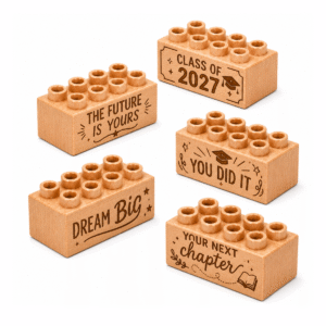 Set of five custom engraved wooden bricks with graduation phrase designs including "The Future Is Yours," "Class of 2027," "Dream Big," "You Did It," and "Your Next Chapter"