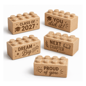 Set of five custom engraved wooden bricks with graduation phrase designs including "Class of 2027," "You Did It!," "Dream Big," "Next Chapter," and "Proud of You"