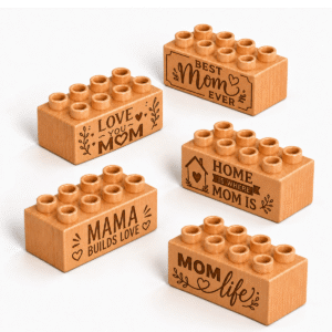 Set of five custom engraved wooden Plus bricks with Mother's Day phrase designs including "Best Mom Ever," "Love You Mom," "Mama Builds Love," "Home Mom Is," and "Mom Life"