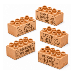 Set of five custom engraved wooden bricks with new home phrase designs including "Our First Home," "Home Sweet Home," "New Home New Memories," "Love Lives Here," and "Welcome Home"