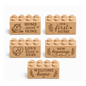 Set of five custom engraved wooden bricks with home phrase designs including "Home Sweet Home," "Our First Home," "Love Lives Here," "New Beginnings," and "Welcome Home"
