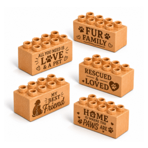 Set of five custom engraved wooden bricks with pet phrase designs including "Fur Family," "All You Need Is Love & a Pet," "Rescued & Loved," "My Best Friend," and "Home Is Where the Paws Are"
