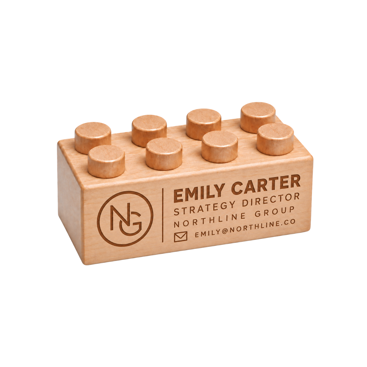 Wooden brick business card engraved with a name, company details, and a monogram logo.