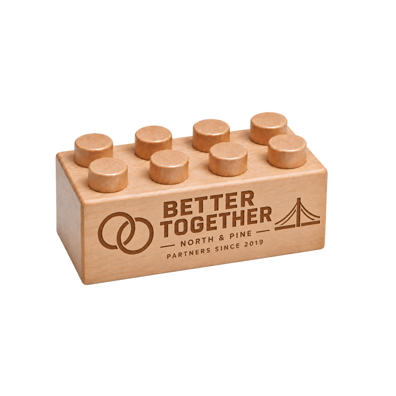Wooden brick engraved with ‘Better Together,’ linked rings and a bridge design to celebrate a business partnership.