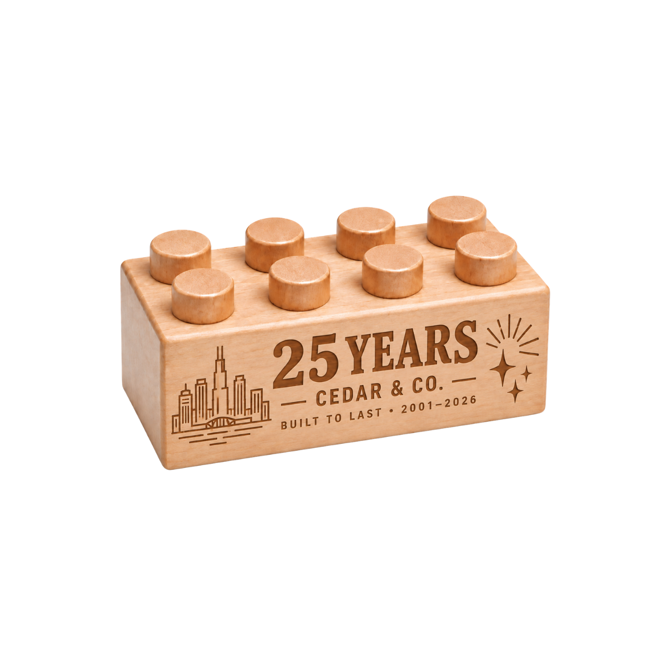 Wooden brick engraved with ‘25 Years,’ Cedar & Co. branding and a city skyline to mark a company anniversary.