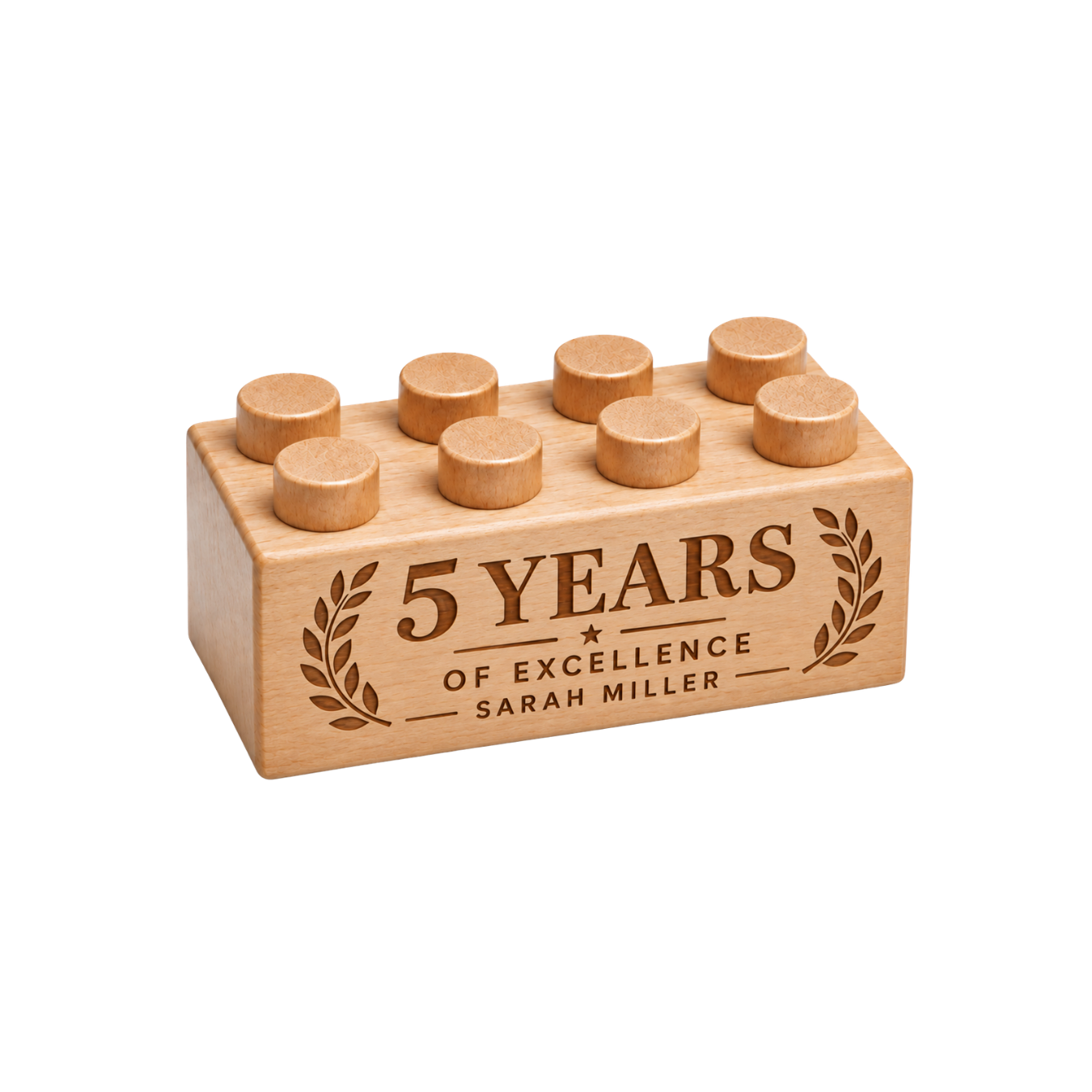 Wooden brick engraved with 5 Years of Excellence and Sarah Miller, framed by laurel branches.