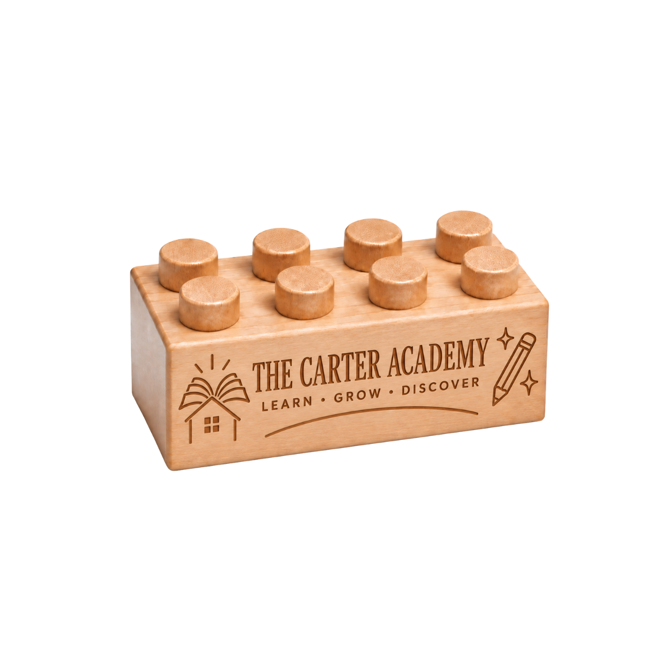 Wooden brick engraved with The Carter Academy and Learn Grow Discover, with an open book, house, and pencil.