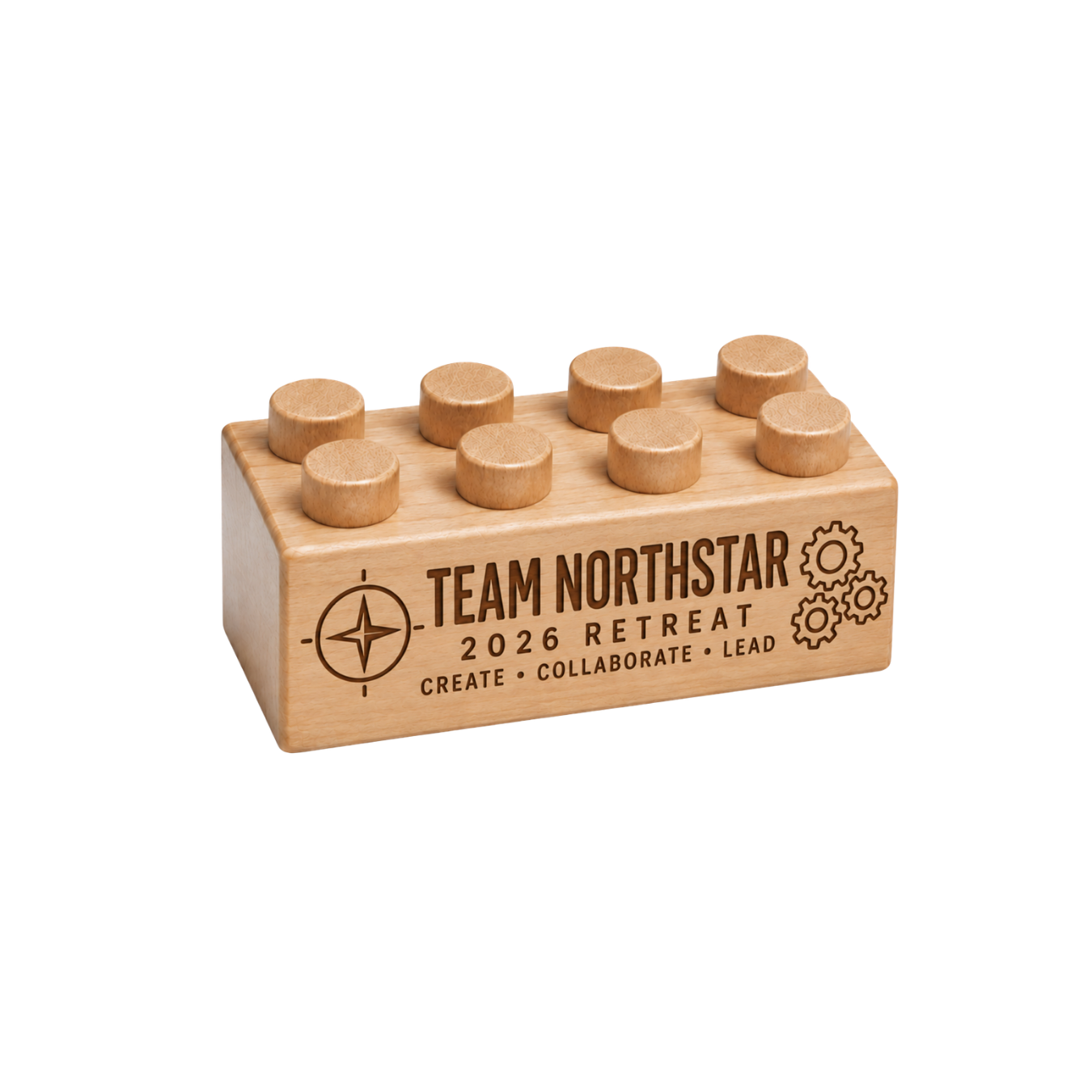 Wooden brick engraved with Team Northstar, 2026 Retreat, Create Collaborate Lead, a compass, and gears.