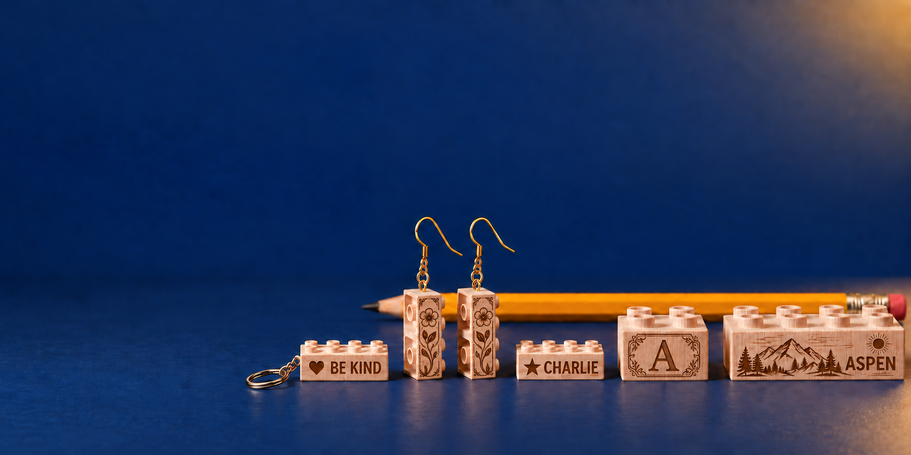 Wooden Be Kind keychain, floral brick earrings, Charlie name brick, ornate A monogram, and Aspen mountain engraving.