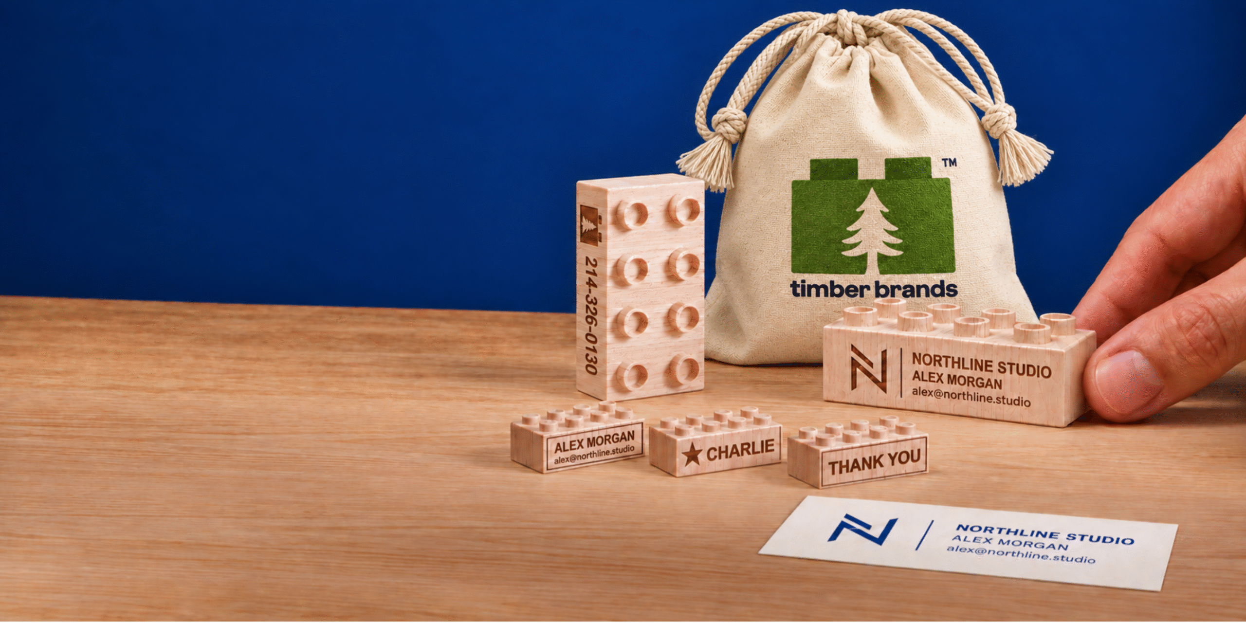 Timber Brands canvas bag with laser-engraved wooden bricks showing a business logo, contact details, a name and a thank-you message