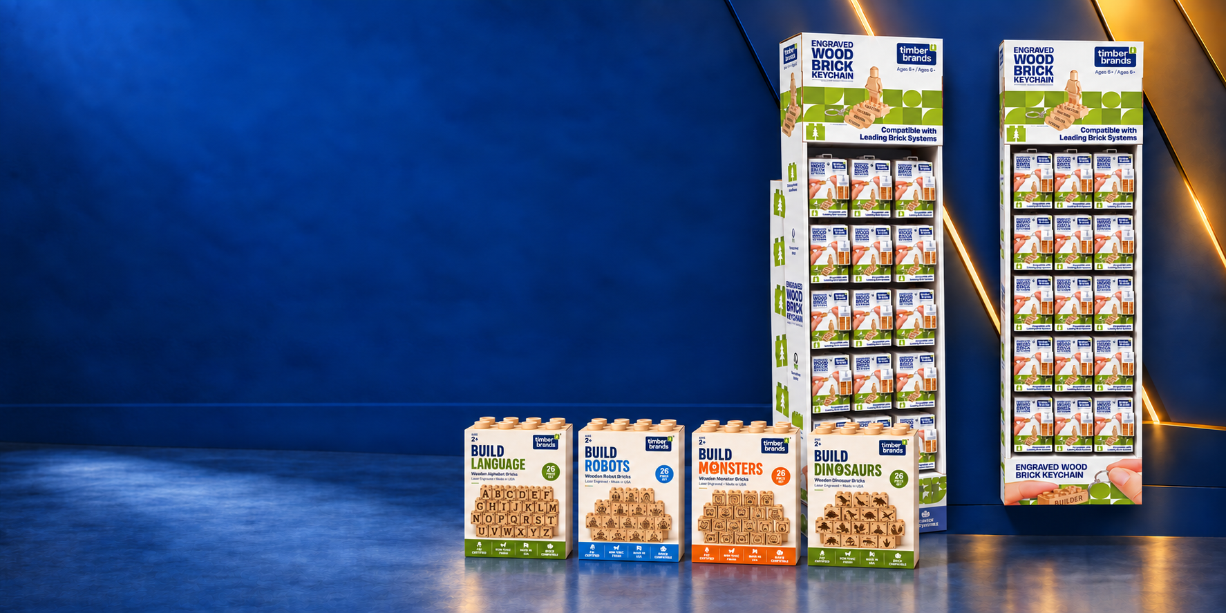 Timber Brands wooden brick keychain retail displays alongside boxed alphabet, robot, monster, and dinosaur brick sets.